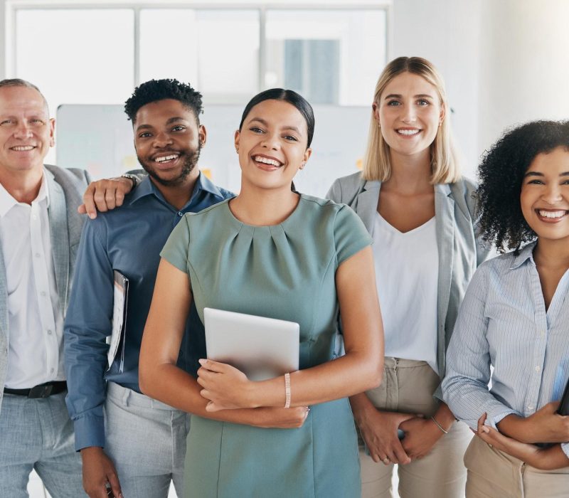 Team of professionals in a digital marketing office smiling together.